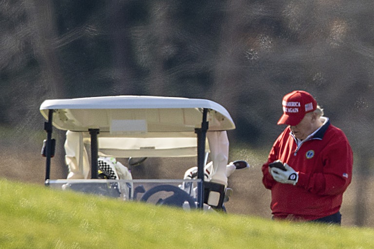 Donald Trump texts while golfing