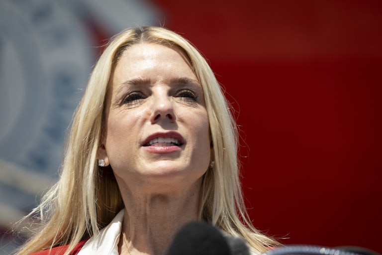 Attorney General Pam Bondi speaks into a microphone