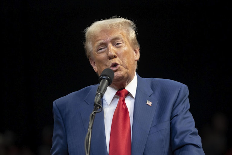 Donald Trump speaking at a mic