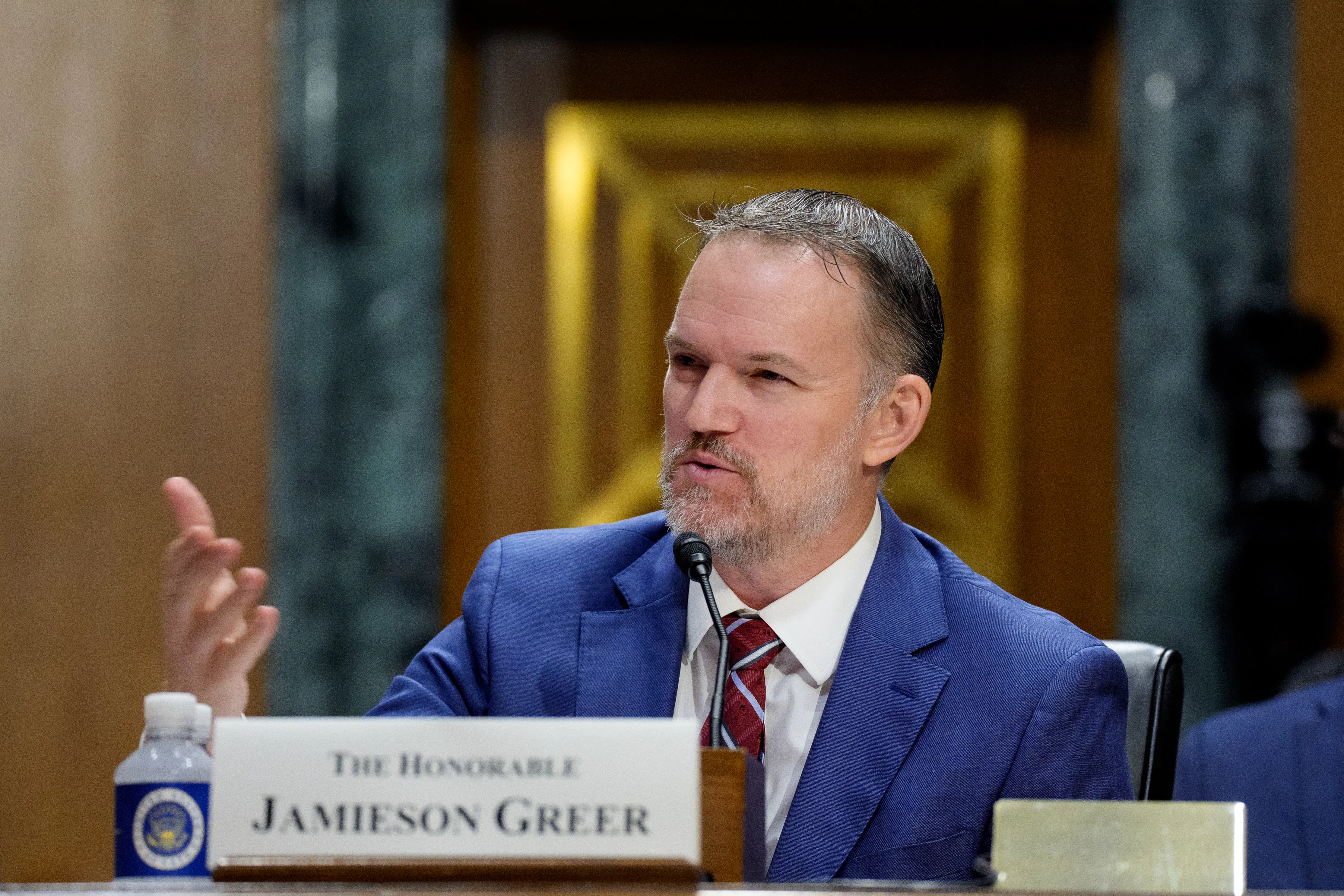 Trade Ambassador Jamieson Greer gestures while speaking during a Senate committee hearing.