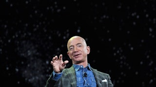 Jeff Bezos squints gestures while speaking to an audience 