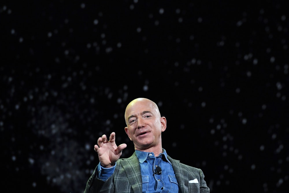 Jeff Bezos squints gestures while speaking to an audience