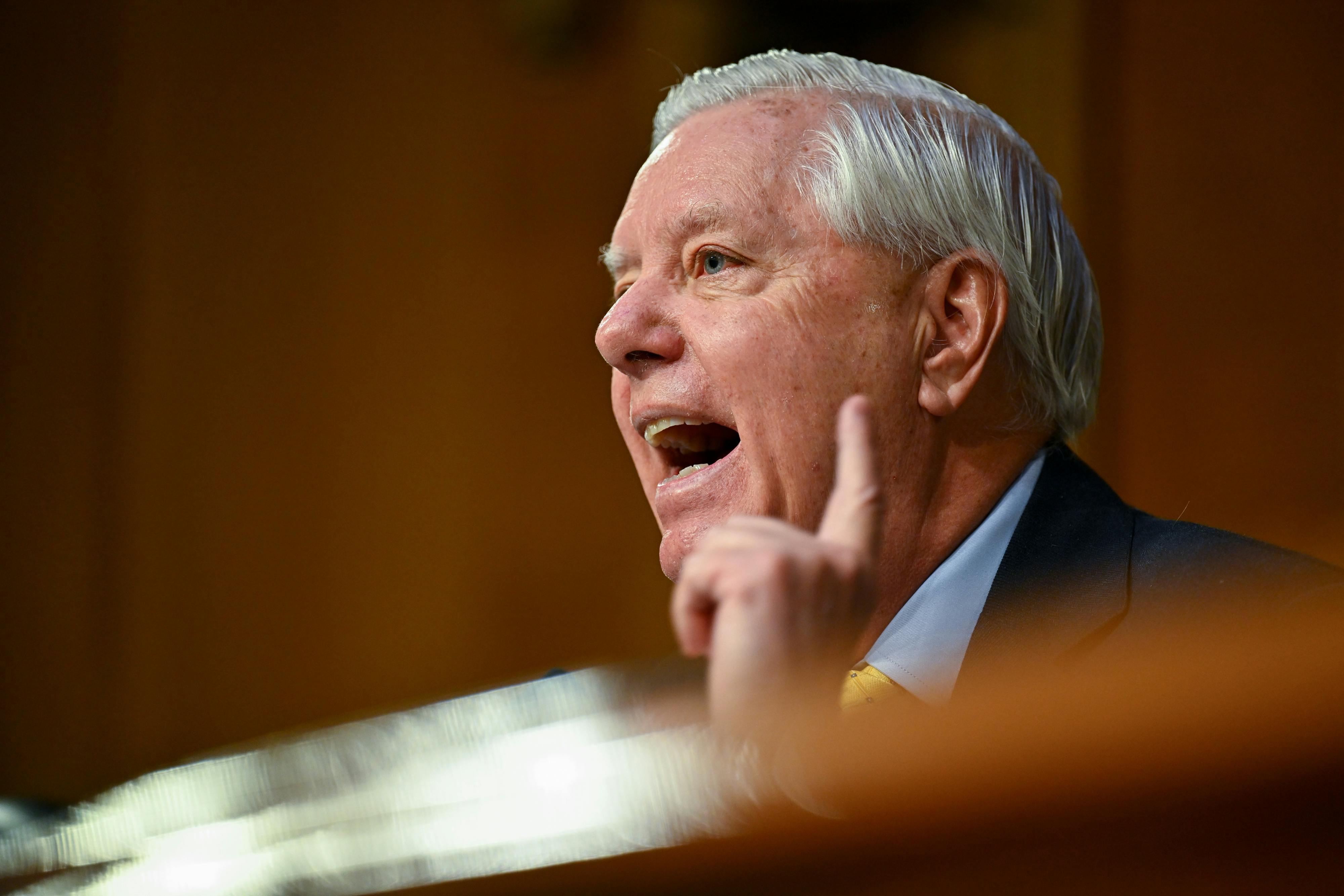 Senator Lindsey Graham raises a finger while speaking during a hearing