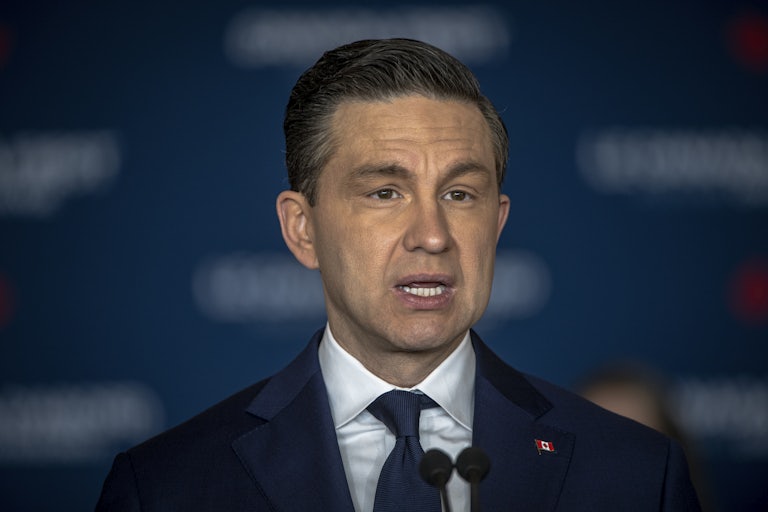Canada's Conservative Party Leader Pierre Poilievre speaks at a mic
