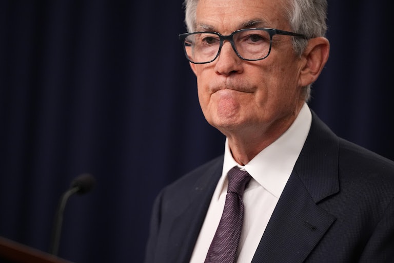 Fed Reserce Chair Jerome Powell pures his lips in a grim line.