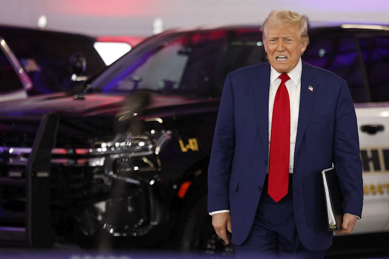 Donald Trump speaks as he arrives at a campaign event