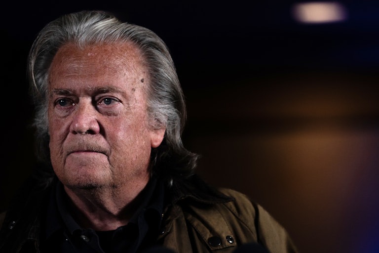 Steve Bannon frowns while speaking to reporters