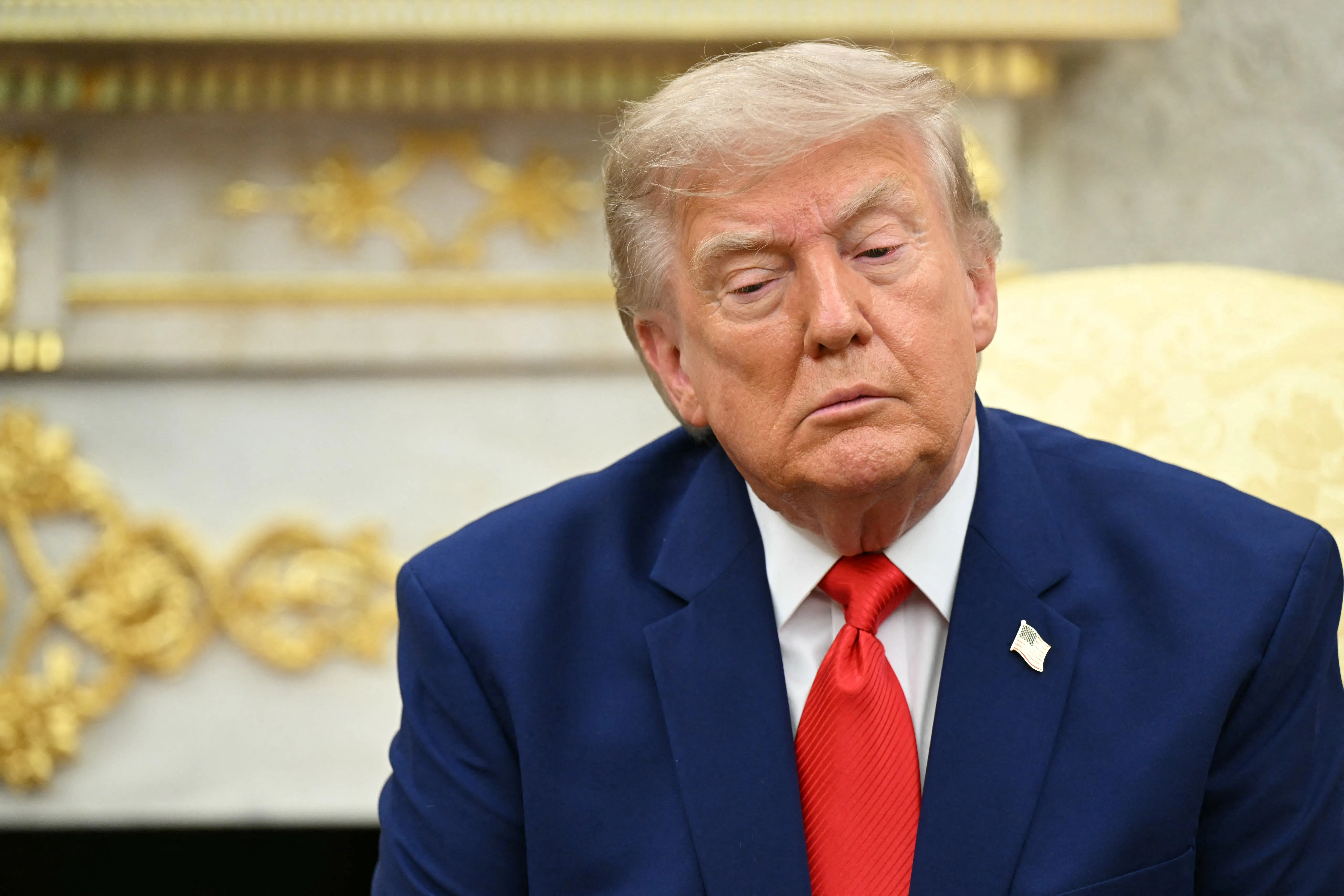 Donald Trump sitting and looking downcast