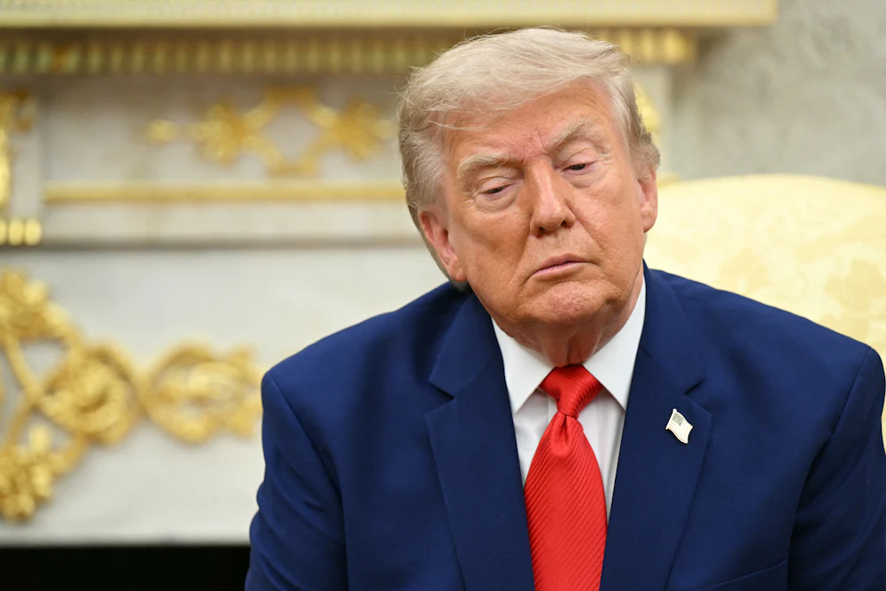 Donald Trump sitting and looking downcast