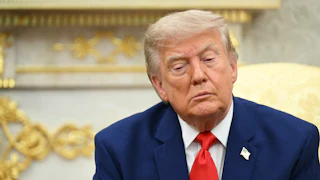 Donald Trump sitting and looking downcast