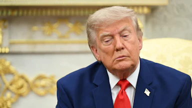 Donald Trump sitting and looking down