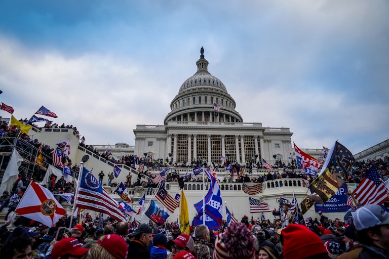 Donald Trump supporters wave flags outside the U.S. Capitol on January 6, 2021
