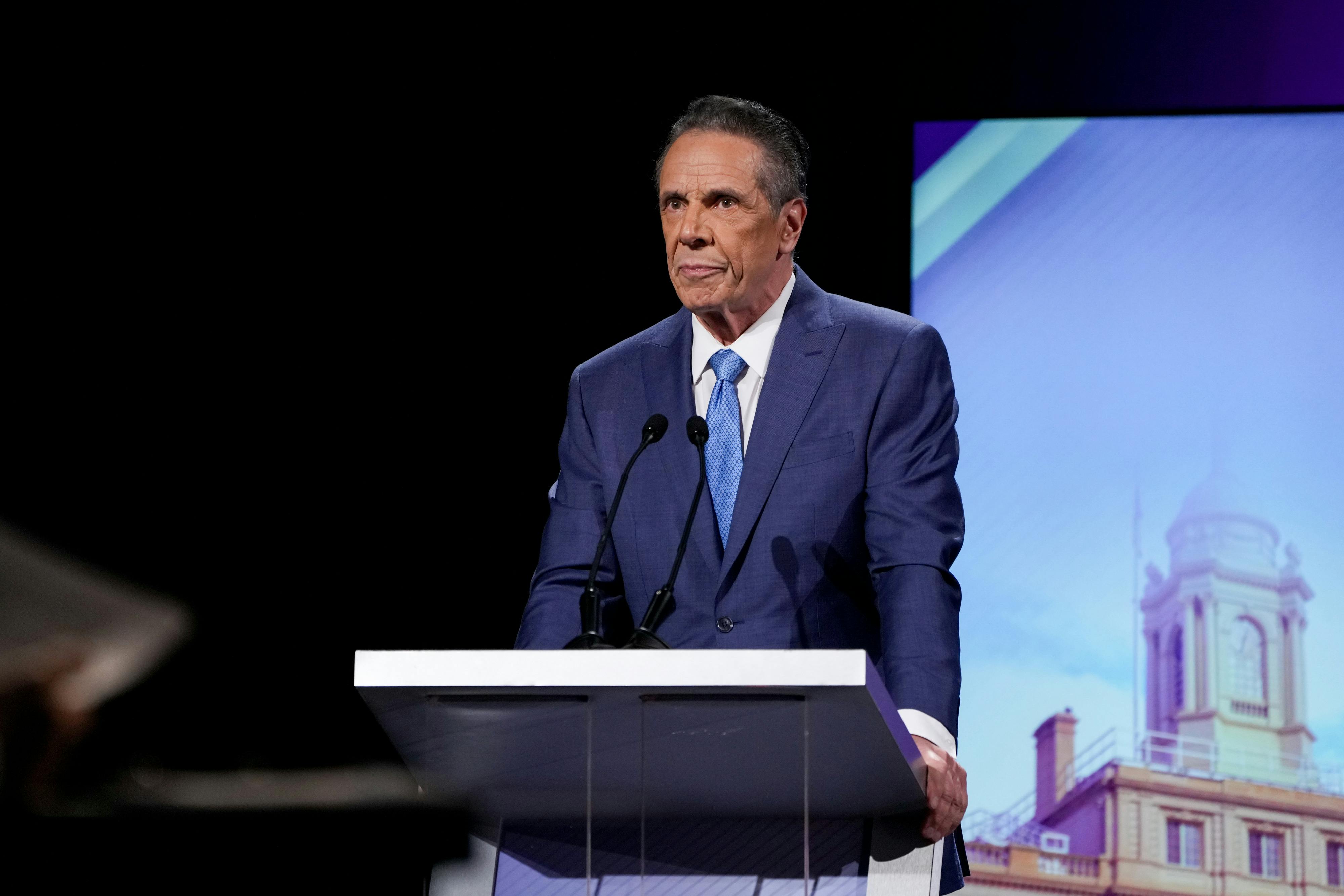 Former Governor Andrew Cuomo stands at a podium onstage during the New York City mayoral debate