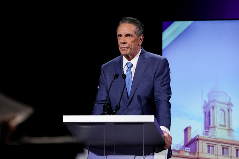 Former Governor Andrew Cuomo stands at a podium onstage during the New York City mayoral debate