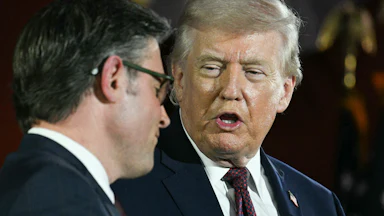 President Donald Trump speaks as House Speaker Mike Johnson listens