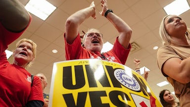 People celebrate at United Auto Workers vote watch party