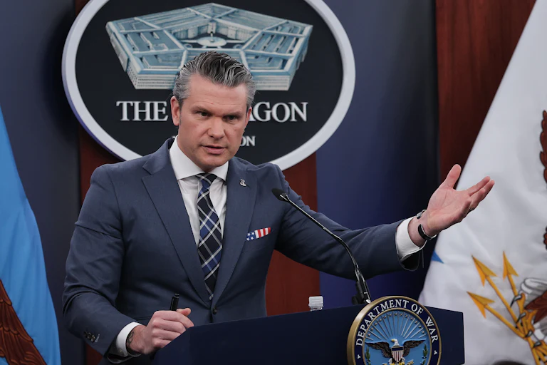 Defense Secretary Pete Hegseth speaks at a podium in a Pentagon press briefing.