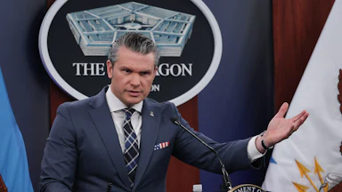Defense Secretary Pete Hegseth speaks at a podium in a Pentagon press briefing.