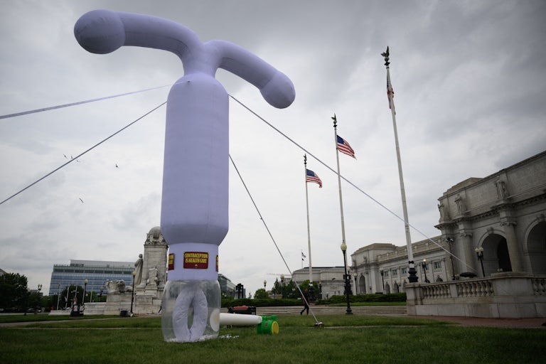 Giant inflatable lavender IUD device on the lawn outside Union Station. It's taller (or as tall as) several U.S. flag poles outside the station.