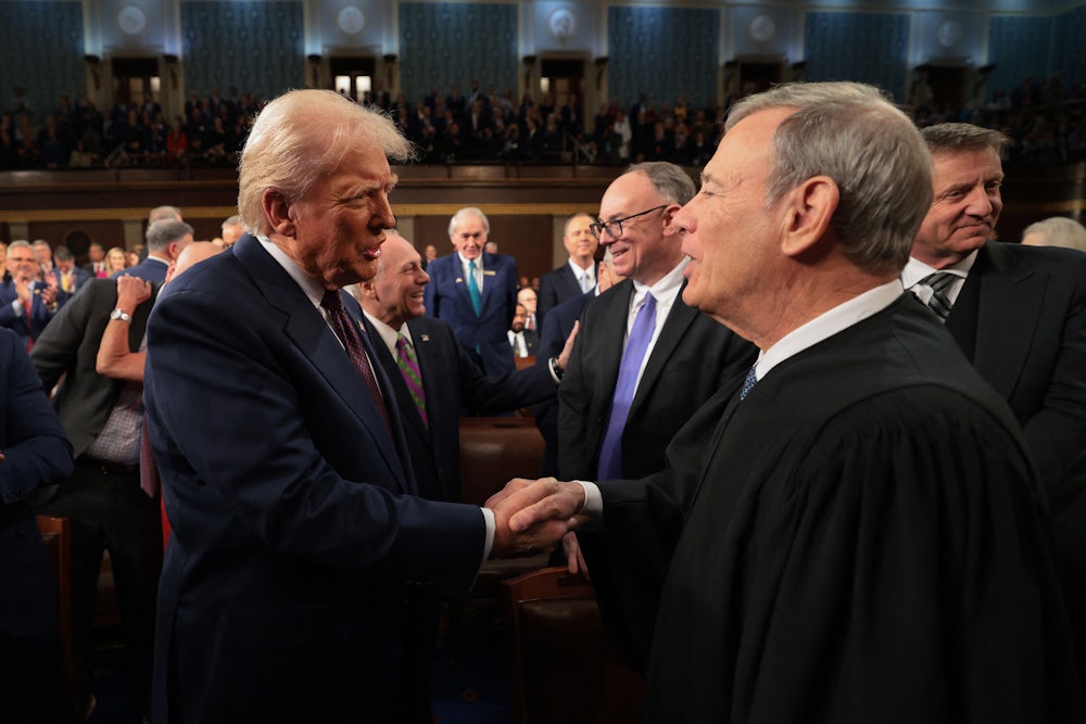 President Donald Trump greets Chief Justice John Roberts.