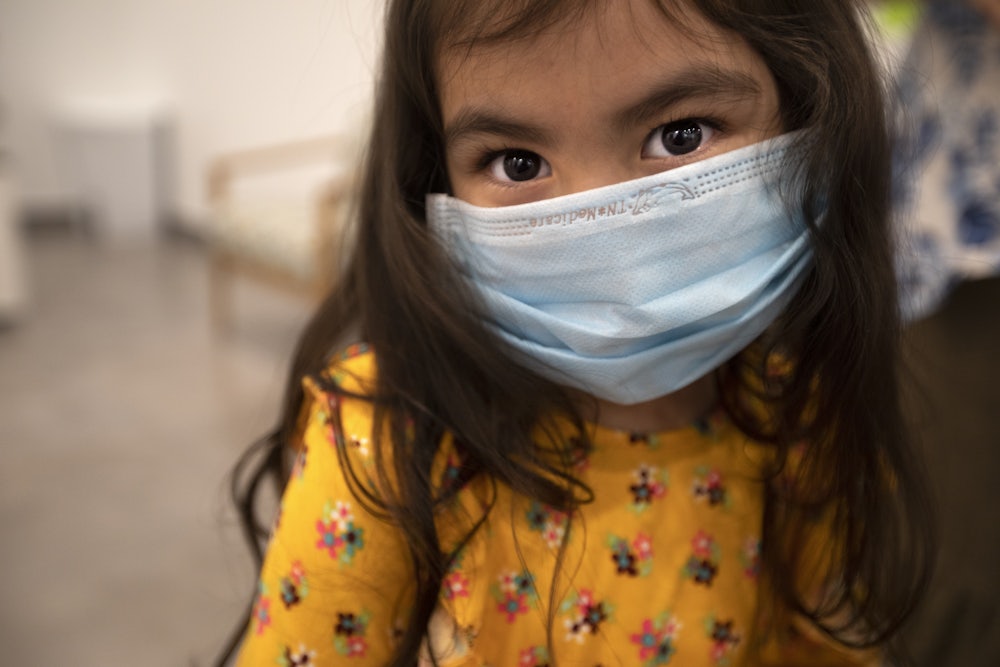 A child wears a face mask.
