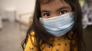 A child wears a face mask.