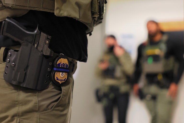 ICE officers stand in the hallway outside an immigration courtroom in New York