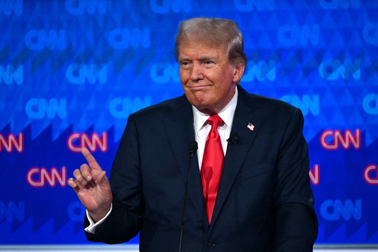 Donald Trump smiles and holds up a finger