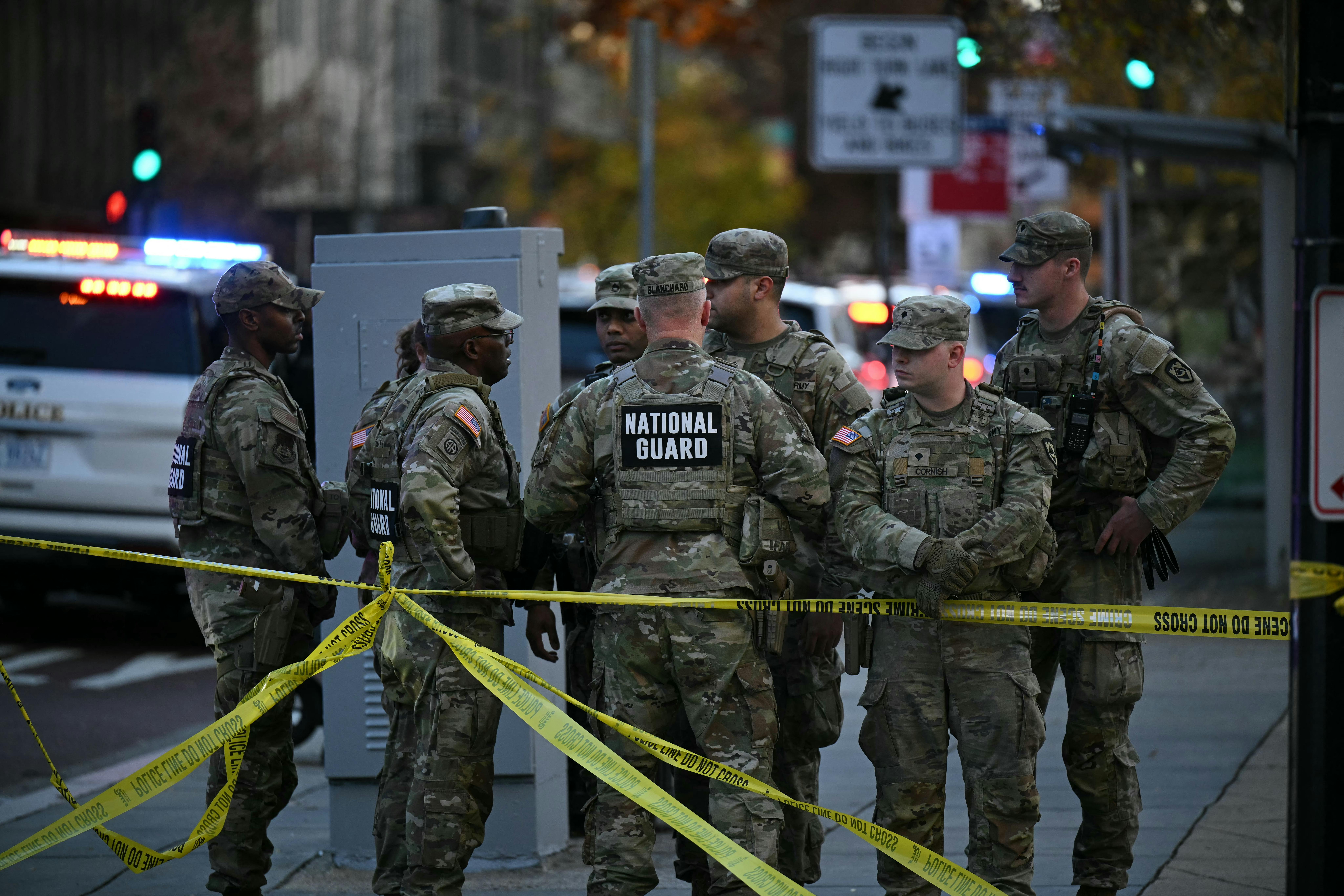 Six National Guard soldiers gather near the crime scene after a shooting in downtown Washington, D.C.