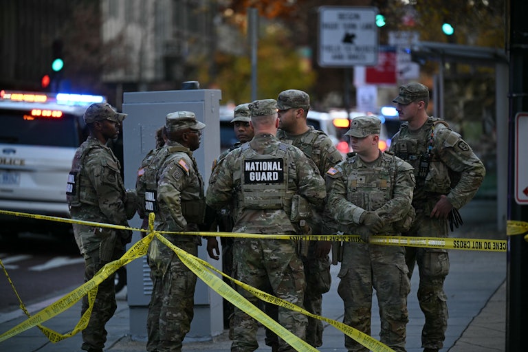 Six National Guard soldiers gather near the crime scene after a shooting in downtown Washington, D.C.