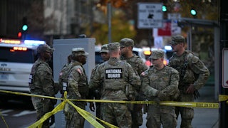 Six National Guard soldiers gather near the crime scene after a shooting in downtown Washington, D.C.