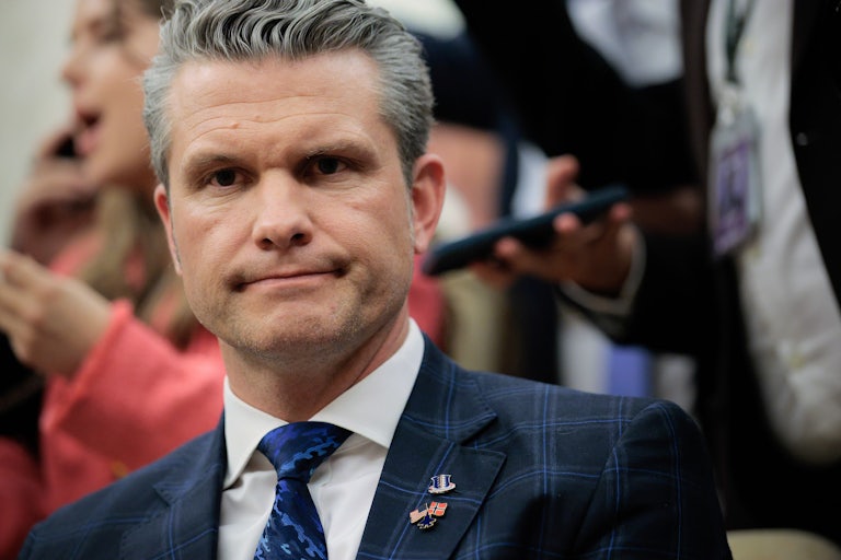 Defense Secretary Pete Hegseth smiles with his mouth closed