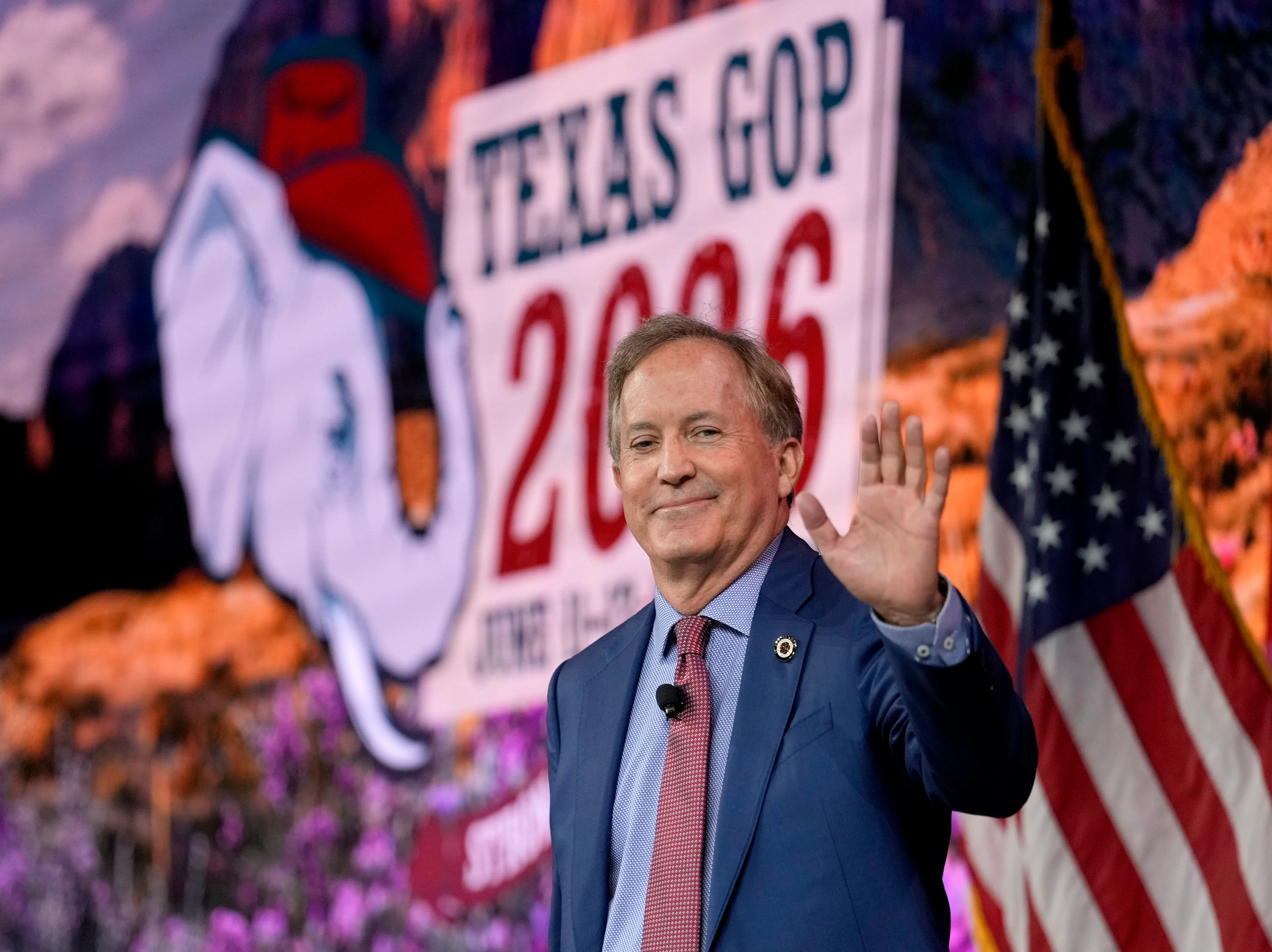 Texas Attorney General Ken Paxton waves while at a campaign event
