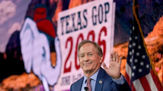 Texas Attorney General Ken Paxton waves while at a campaign event