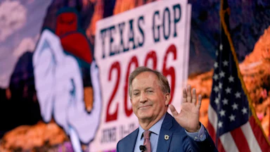 Texas Attorney General Ken Paxton waves while at a campaign event