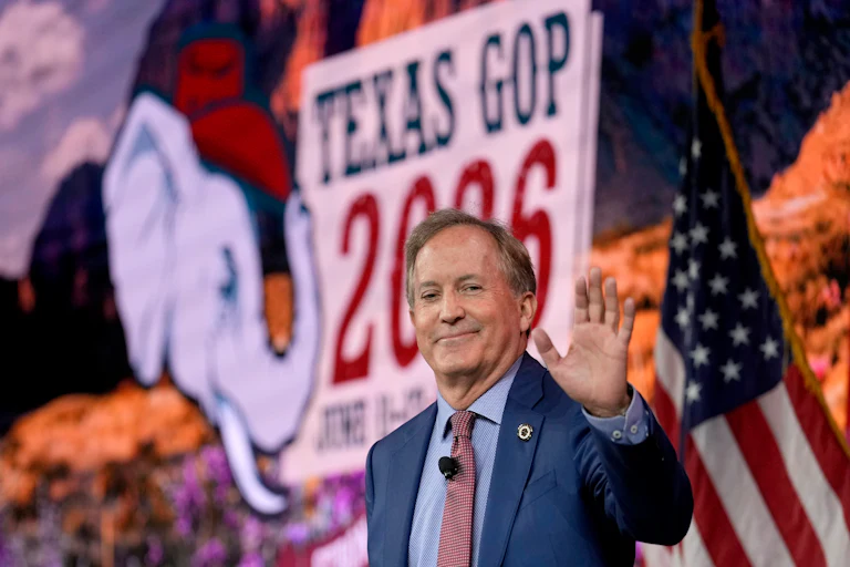 Texas Attorney General Ken Paxton waves while at a campaign event.