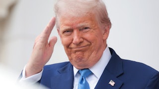 Donald Trump smiles and salutes during an event at Arlington National Cemetery