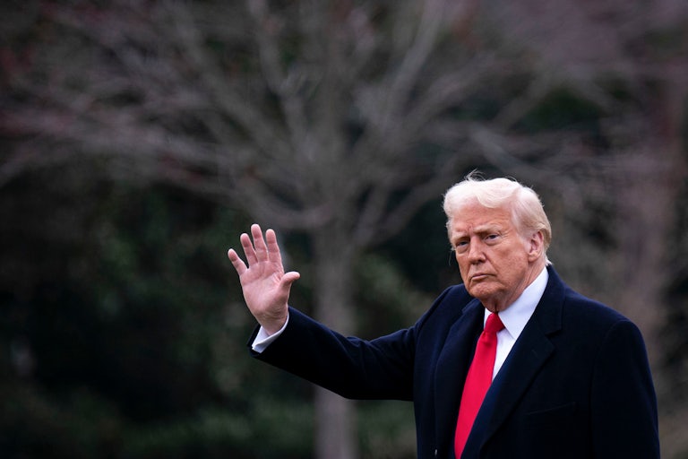 Donald Trump waves while walking outside the White House