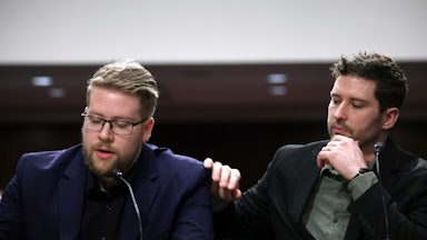 Brent Grancer places his hand on Luke Granger's shoulder as he speaks.