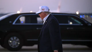 Donald Trump, seen in profile, walks away after disembarking from Air Force One