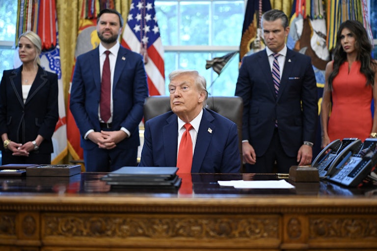 President Donald Trump and other officials in a meeting in the Oval Office.