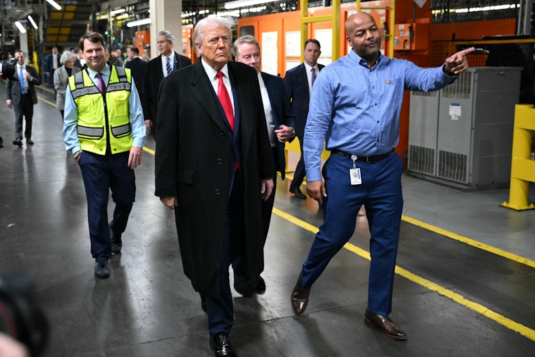 President Donald Trump tours a Ford plant along with three other men.