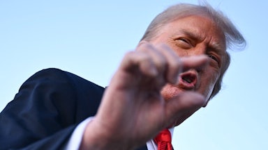 Donald Trump gestures as he speaks to reporters after stepping off Air Force One.
