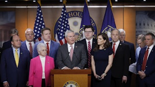 James Comer stands at a podium while other members of his party surround him