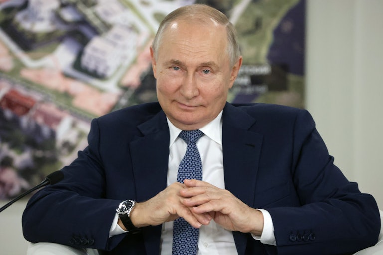 Vladimir Putin smiles in an evil manner