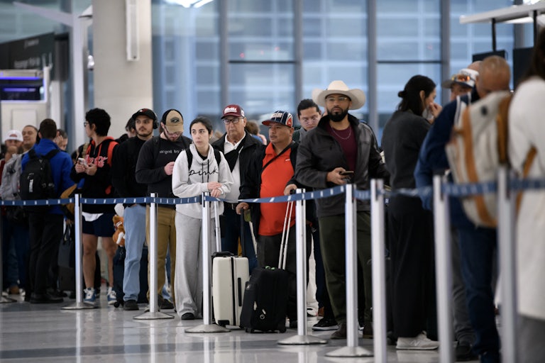People wait in a long security checkpoint George Bush Intercontinental Airport in Houston, Texas.