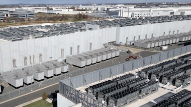 An aerial image shows lots of rectangular metal structures arrayed in rows.