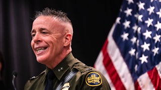 CBP Commander Greg Bovino smiles while speaking during a press conference
