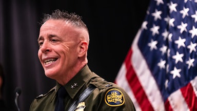 CBP Commander Greg Bovino smiles while speaking during a press conference