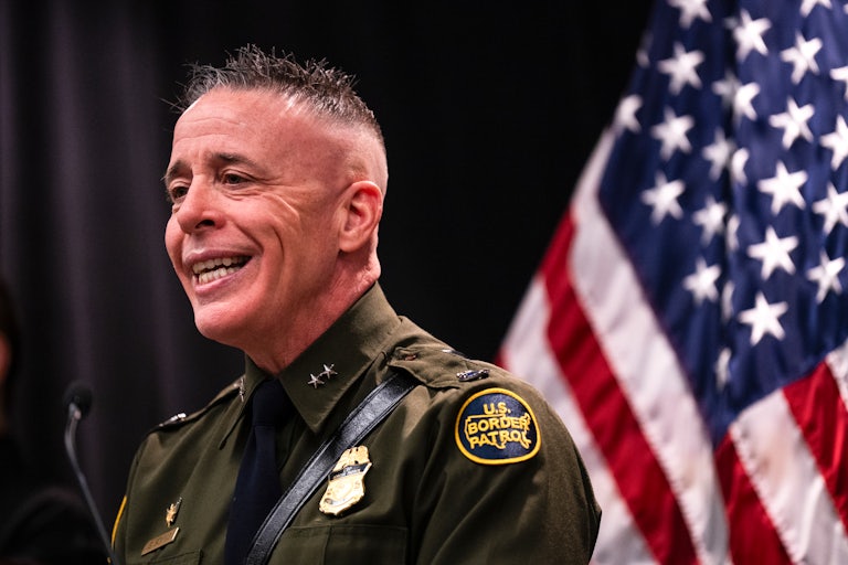 CBP Commander Greg Bovino smiles while speaking during a press conference